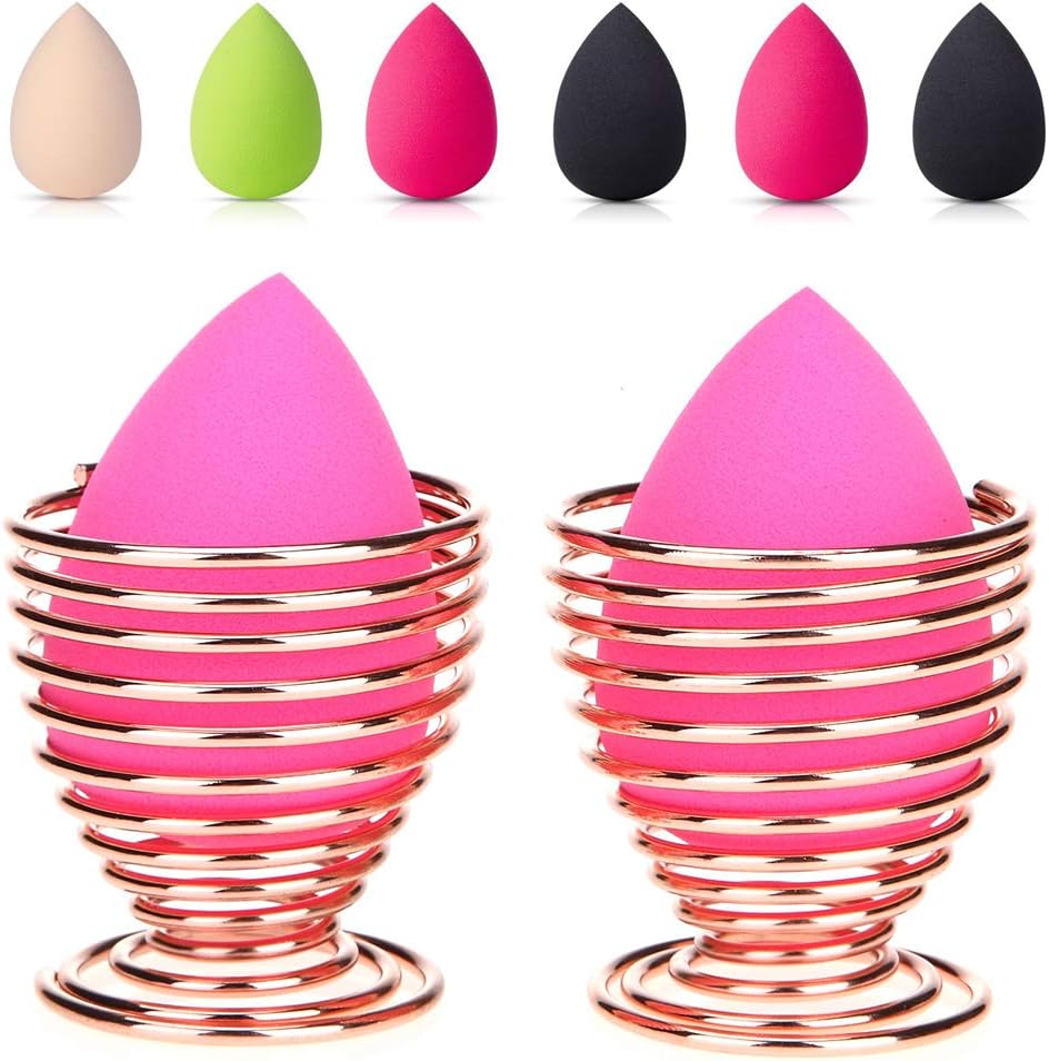 2 Pack Rose Gold Beauty Sponge Blender Holders - Makeup Drying Stands Pair of rose gold metal spiral stands for drying and storing makeup sponges, shown on a dresser.