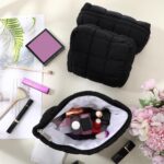 Set of three black puffy quilted checkered cosmetic bags with zippers, shown in various sizes for travel and organization