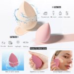 Four pink makeup sponges in various shapes, with a drying holder and a protective egg-shaped storage case