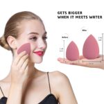 Four pink makeup sponges in various shapes, with a drying holder and a protective egg-shaped storage case