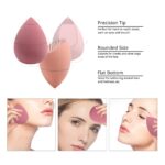 Four pink makeup sponges in various shapes, with a drying holder and a protective egg-shaped storage case
