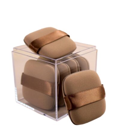 A set of five brown square foundation sponges, shown ready for use with liquid makeup.