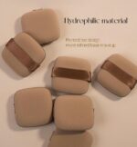 A set of five brown square foundation sponges, shown ready for use with liquid makeup.