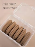 A set of five brown square foundation sponges, shown ready for use with liquid makeup.