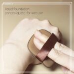 A set of five brown square foundation sponges, shown ready for use with liquid makeup.