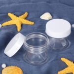 Set of six clear 3 oz plastic jars with white screw-on lids for storage and organization
