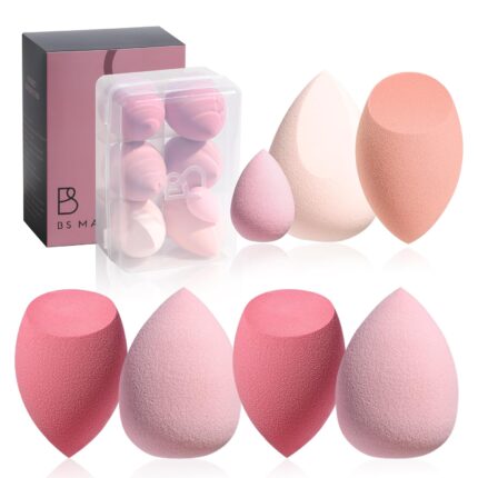 A set of seven pink makeup sponges in various shapes, including one mini, neatly arranged in an open gradient pink storage ca