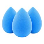 Three yellow teardrop-shaped makeup sponge blenders on a clean surface, ready for foundation application.
