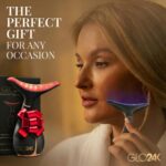 A black LED face and neck massager wand with a sleek design, shown with its protective cover and charging cable.
