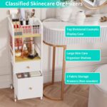 White and wood rolling makeup organizer cart with divided top, open shelf, and two fabric drawers, filled with cosmetics.