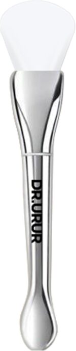 Soft silicone brush applicator for applying face masks, creams, and lotions evenly on the skin, showing the flexible head and