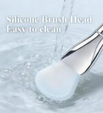 Soft silicone brush applicator for applying face masks, creams, and lotions evenly on the skin, showing the flexible head and